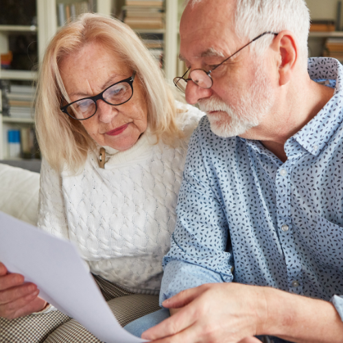 a man and woman in looking at a lasting powers of attorney form